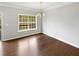 Bright dining room features hardwood floors, a large window and a stylish gold chandelier at 1100 Cotton Gin Dr, Woodstock, GA 30188