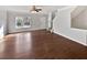 Open-concept living room with hardwood floors, gray walls, ceiling fan, and staircase at 1100 Cotton Gin Dr, Woodstock, GA 30188