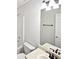 Bright bathroom featuring a shower and vanity with modern fixtures and a well-lit mirror at 213 Ermines Way, Mcdonough, GA 30253