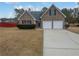 Charming home with a two-car garage and well-maintained lawn at 213 Ermines Way, Mcdonough, GA 30253