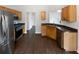 Well-lit kitchen featuring stainless steel appliances and wood cabinets at 213 Ermines Way, Mcdonough, GA 30253