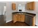 Kitchen featuring stainless steel appliances, wood cabinets, and a view to living area at 213 Ermines Way, Mcdonough, GA 30253