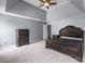 Spacious bedroom featuring tray ceilings, carpet, and neutral-colored walls at 2230 Atkinson Park Dr, Lawrenceville, GA 30043