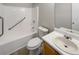 Bathroom featuring a tiled tub, toilet, and sink with mirror at 2545 Lakemeadow Ln, Grayson, GA 30017