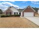 Charming single-story home with a brick and white facade, complemented by a well-manicured lawn at 2545 Lakemeadow Ln, Grayson, GA 30017