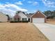 Charming single-story home with a brick and white facade, complemented by a well-manicured lawn at 2545 Lakemeadow Ln, Grayson, GA 30017