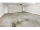 Two car garage with a cement floor, storage, and lighting at 2545 Lakemeadow Ln, Grayson, GA 30017
