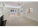 Bright living room featuring a fireplace, ceiling fan, and an opening into the kitchen at 2545 Lakemeadow Ln, Grayson, GA 30017