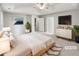 Serene main bedroom with tray ceiling, walk-in closet, and calm decor, virtually staged at 2545 Lakemeadow Ln, Grayson, GA 30017