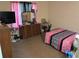 Bedroom with a bed, dresser, television, and pink accents at 2041 Marbut Trce, Lithonia, GA 30058