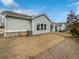 View of the home's backyard and exterior featuring lawn, siding, and a screened patio at 2976 Rambler Dr, Loganville, GA 30052