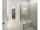 Bright bathroom featuring a glass door shower with a built-in bench at 2976 Rambler Dr, Loganville, GA 30052