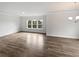 Spacious living room with hardwood floors, crown molding, recessed lighting, and large windows at 2976 Rambler Dr, Loganville, GA 30052