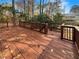 Spacious wooden back deck surrounded by trees, ideal for outdoor entertaining and relaxation at 7040 Northgreen Dr, Atlanta, GA 30328