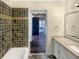 Well-maintained bathroom featuring a shower-tub combo, vanity with granite counter, and a large mirror at 7040 Northgreen Dr, Atlanta, GA 30328