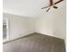 Carpeted bedroom with a ceiling fan and a window at 7040 Northgreen Dr, Atlanta, GA 30328