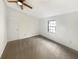 Cozy bedroom with neutral-toned carpet, white walls, a ceiling fan and a window for natural light at 7040 Northgreen Dr, Atlanta, GA 30328