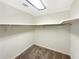 Walk in closet with carpeted floor and rod and shelf storage at 7040 Northgreen Dr, Atlanta, GA 30328