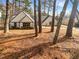 Charming single-Gathering home featuring a well-manicured lawn and mature trees, creating a serene and inviting curb appeal at 7040 Northgreen Dr, Atlanta, GA 30328