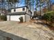Two car garage with driveway, attached to the rear of the home at 7040 Northgreen Dr, Atlanta, GA 30328