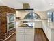 Modern kitchen with white cabinets, granite countertops, stainless steel appliances, and an island cooktop at 7040 Northgreen Dr, Atlanta, GA 30328