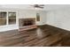 Cozy living room featuring a brick fireplace, ceiling fan, hardwood floors, and lots of light at 7040 Northgreen Dr, Atlanta, GA 30328