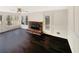 This bright living room features a brick fireplace and hardwood floors for comfort and charm at 7040 Northgreen Dr, Atlanta, GA 30328
