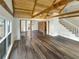 Bright open living room featuring hardwood floors, a brick wall, and vaulted ceilings at 7040 Northgreen Dr, Atlanta, GA 30328