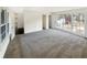 Bright living room featuring a large window, neutral walls and carpet, with views of the outdoor space at 7040 Northgreen Dr, Atlanta, GA 30328