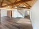 Bright open living room featuring hardwood floors, a brick wall, and vaulted ceilings at 7040 Northgreen Dr, Atlanta, GA 30328