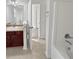 Bathroom with large mirror, tub and sink with dark wooden cabinets at 7088 Blairs View Dr # 4, Austell, GA 30168