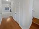 Hallway with hardwood floors leading to a spacious living room featuring a fireplace and a ceiling fan at 7088 Blairs View Dr # 4, Austell, GA 30168