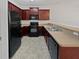 Kitchen with updated countertops, black appliances, and plenty of cabinet space at 7088 Blairs View Dr # 4, Austell, GA 30168
