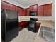 Functional kitchen with dark wood cabinets and appliances including microwave and range at 7088 Blairs View Dr # 4, Austell, GA 30168