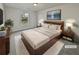 Staged main bedroom with a cozy rug, TV, and modern decor at 7088 Blairs View Dr # 4, Austell, GA 30168