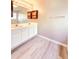 Bright bathroom featuring double sink vanity, and wood-look flooring at 2011 Atkinson Park Dr, Lawrenceville, GA 30043