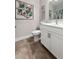 Bathroom features white vanity, toilet, wall art, and tile flooring at 206 William Creek Dr, Canton, GA 30115