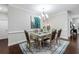 Elegant dining space with stylish table for six, modern lighting, and peacock artwork at 206 William Creek Dr, Canton, GA 30115