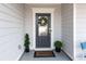 Close-up of the elegant front door with a glass window and dark paint, flanked by potted plants at 206 William Creek Dr, Canton, GA 30115