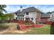 Landscaped backyard with a wooden deck, mulch flower beds, and shade tree at 2875 Ivy Brook Ln, Buford, GA 30519