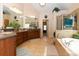 A spacious bathroom featuring a tiled floor, garden tub, and double vanity at 2875 Ivy Brook Ln, Buford, GA 30519