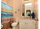 Cozy bathroom with a shower featuring a beach themed shower curtain, and a standard toilet and vanity at 2875 Ivy Brook Ln, Buford, GA 30519