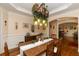 Cozy dining room with a wooden table and unique hanging floral light fixture at 2875 Ivy Brook Ln, Buford, GA 30519