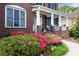 Beautiful home showcasing vibrant landscaping and a welcoming front porch with classic columns at 2875 Ivy Brook Ln, Buford, GA 30519