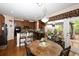Eat-in kitchen with custom cabinets, granite countertops, stainless steel appliances, and an adjacent dining area at 2875 Ivy Brook Ln, Buford, GA 30519
