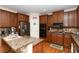 Bright kitchen featuring hardwood floors, granite countertops, stainless steel appliances and custom wooden cabinets at 2875 Ivy Brook Ln, Buford, GA 30519