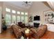 Bright living room with large windows, fireplace, and built-in bookshelves at 2875 Ivy Brook Ln, Buford, GA 30519