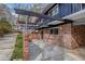 Exterior view featuring brick facade, covered patio, and steps to the house's upper level at 3894 Foxford Dr, Atlanta, GA 30340