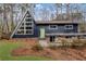 Unique A-frame home boasting a modern design, green door, and landscaped front yard at 3894 Foxford Dr, Atlanta, GA 30340