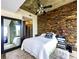 Bedroom with large mirror, decorative stone wall, and modern decor at 860 Peachtree St # 811, Atlanta, GA 30308